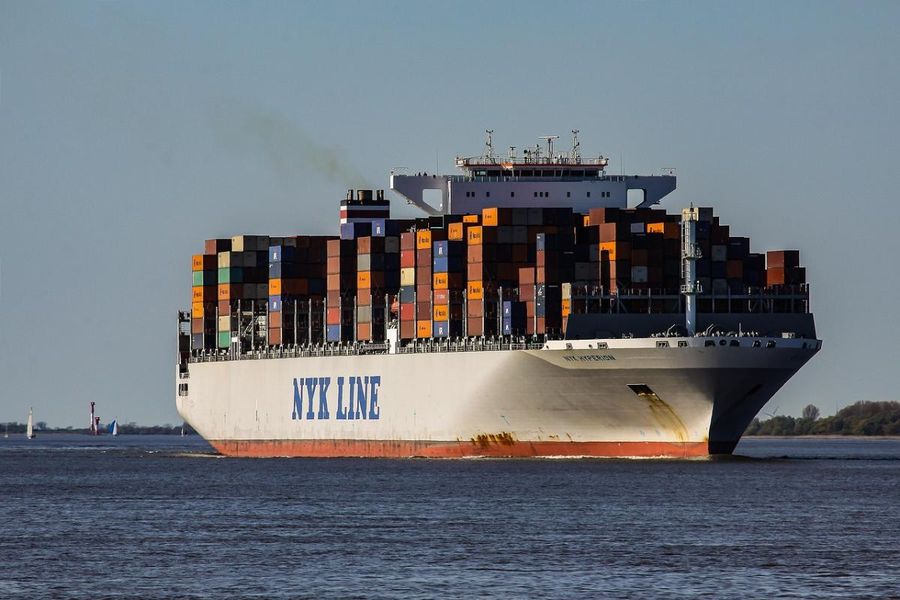 Large container ship sailing at sea during golden hour