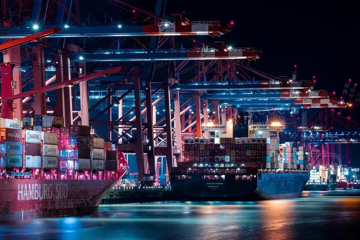 Container terminal lit up at night, representing Texlora International's DDP and FOB shipping terms